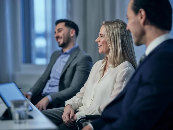 People in a meeting working together smiling