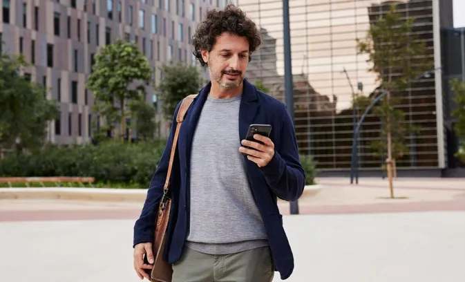 Man walking in the street using mobile phone